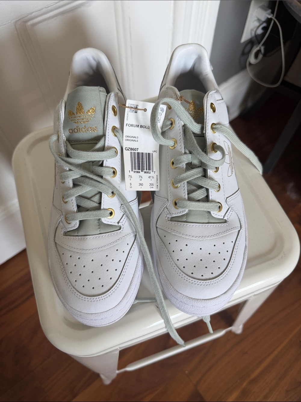 adidas White Sneakers with Light Green Accents and Gold Logo